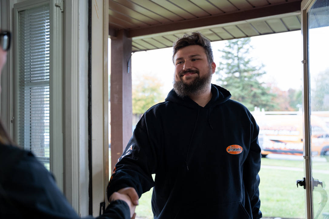 HVAC technician at customer door in Toledo Ohio
