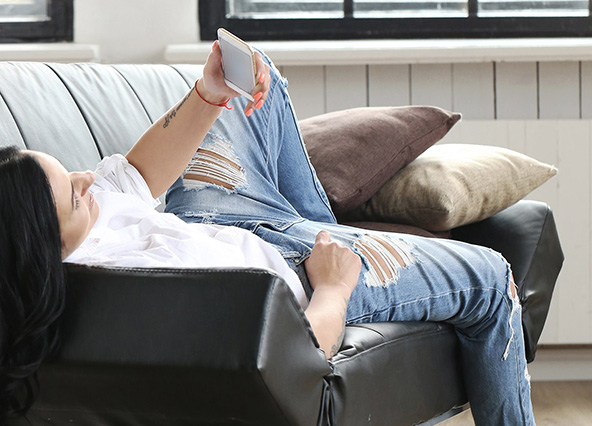 Man comfortable on couch after completed air conditioning repair in Perrysburg, OH
