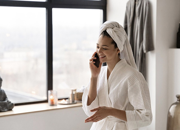 Woman enjoying warm water after water heater repair by Ricks Affordable Heating & Cooling