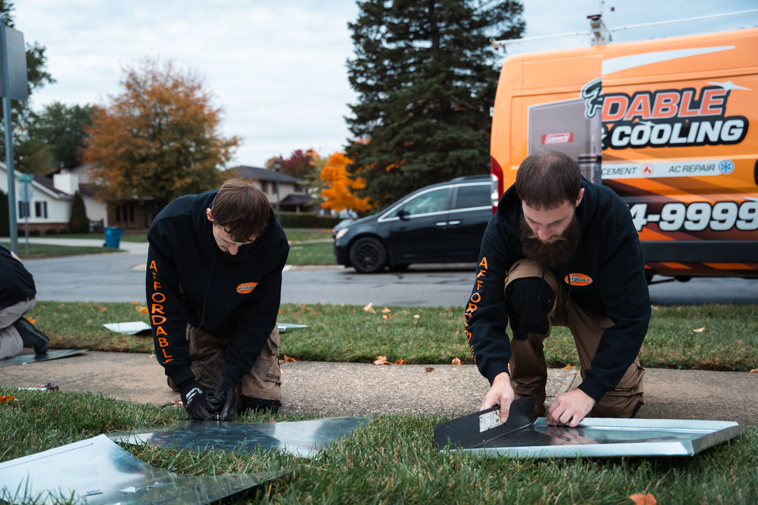 Rick's Affordable technicians preparing ductwork for AC installation on-site